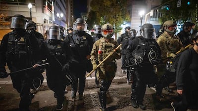 Soldiers with the National Guard help local police disperse antifascist protesters following the US presidential elections in Portland, Oregon. EPA