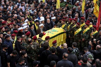 Mourners gather near the coffin of Hezbollah member Jaafar Serhan, who was killed while deployed in Syria with Hezbollah, during his funeral in Mashghara, Lebanon, November 13, 2023. Reuters