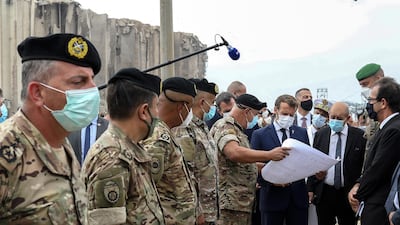 French President Emmanuel Macron and French Foreign Minister Jean-Yves Le Drain meet the military mobilised to help to rebuild the port of Beirut. AP via pool