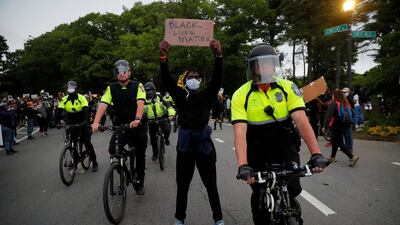 A demonstrator holds a sign during a rally following the death in Minneapolis police custody of George Floyd, in Boston, Massachusetts. Reuters