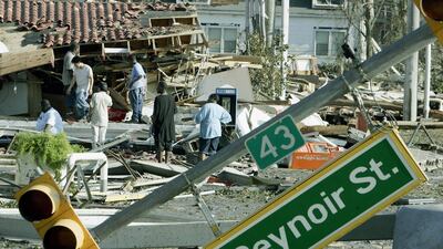 Residents inspect damage left by Hurricane Katrina on August 30, 2005 in Biloxi, Mississippi. At least 80 people were feared dead along the coast of the southern state of Mississippi, where glitzy casinos, plush homes and shrimp fishing businesses lay in ruins, after a storm surge up to 10 metres high crashed ashore. Helpless authorities in New Orleans, meanwhile, watched as surging floodwaters gushed through a 600-metre hole in the 17th Street Canal defences, inundating a low-lying city already 80 per cent under water. AFP