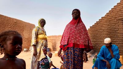 A displaced family stands in a courtyard in Sevare where they found a shelter after fleeing their village of Guerri in central Mali, on February 27, 2020. AFP