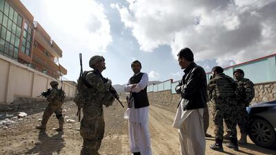 Afghan residents chat with US. Army Lieutenant Steven Gibbs as he patrols with his platoon in Pul-e Alam, a town in Logar province, eastern Afghanistan in 2011. Reuters