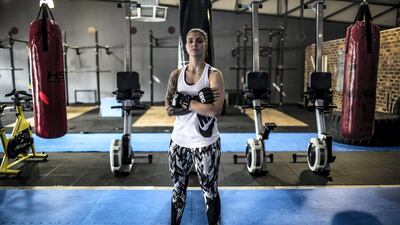 Shana Power, a mixed martial artist, poses in the gym that she co-owns in Johannesburg. AFP
