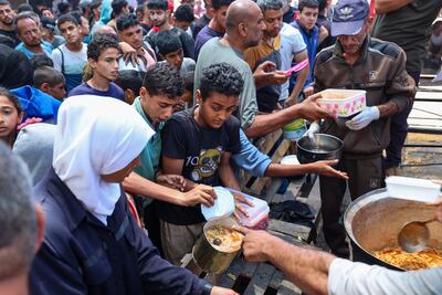 Palestinians wait for food at a distribution point in Nuseirat in central Gaza. AFP
